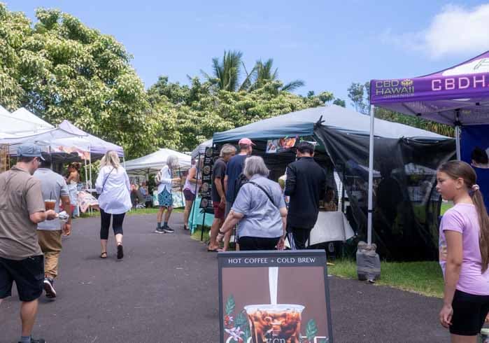 Eight shirts arranged on table in black, olive, grey, blue, white, red, mustard, and green.
